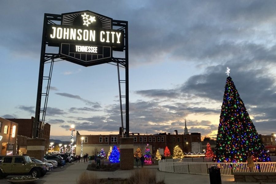 Johnson City, TN Insurance - Johnson City Tennessee Sign Lit Up At Night Time With a Large Christmas Tree Lit Up Beside It