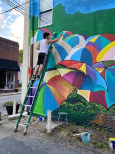Umbrella Alley - Artist Painting Mural
